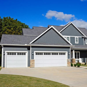 Blue House with White Garage Doors