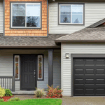 black classic garage door on contemporary home in the fall