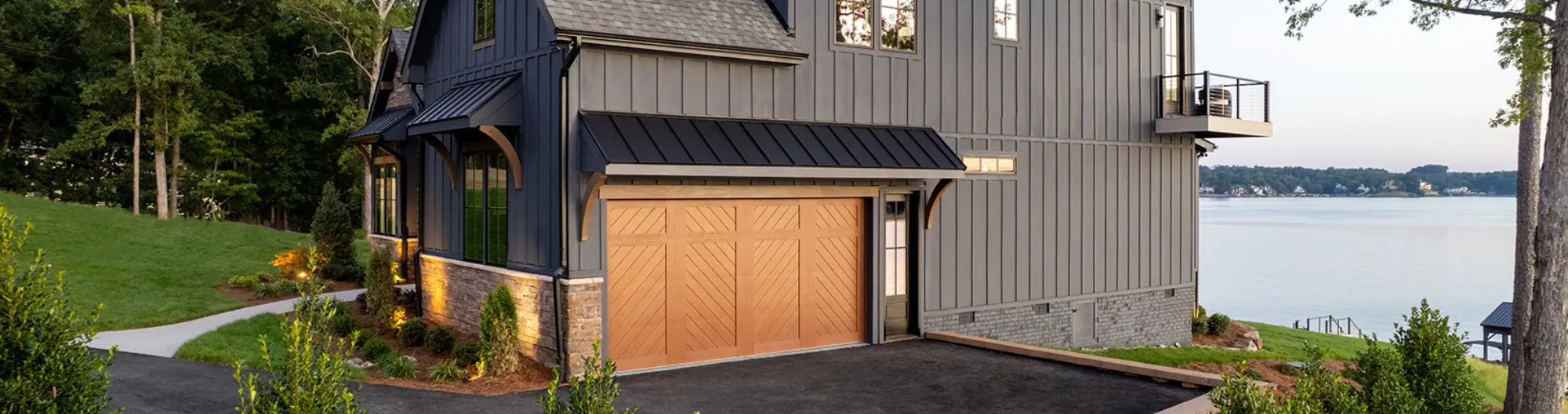 brown chevron style garage door on black lakefront home